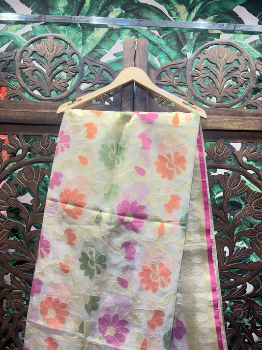 Floral-patterned fabric on a hanger against a decorative wooden background