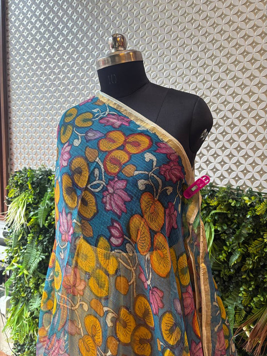 A close-up of the teal blue and yellow lotus print dupatta, highlighting the sheer texture of the Kota Doria weave.