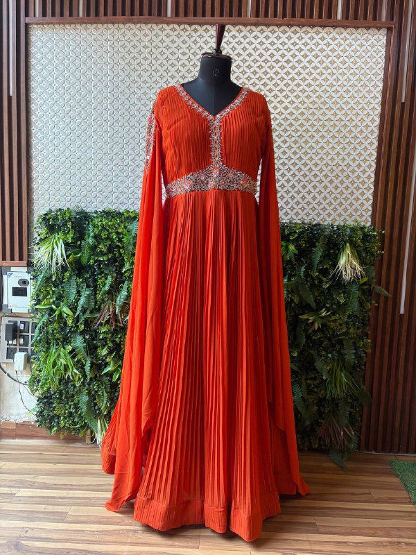 Regal Rust Pleated Gown with Embellished Cape Sleeves by Lable Rosaya