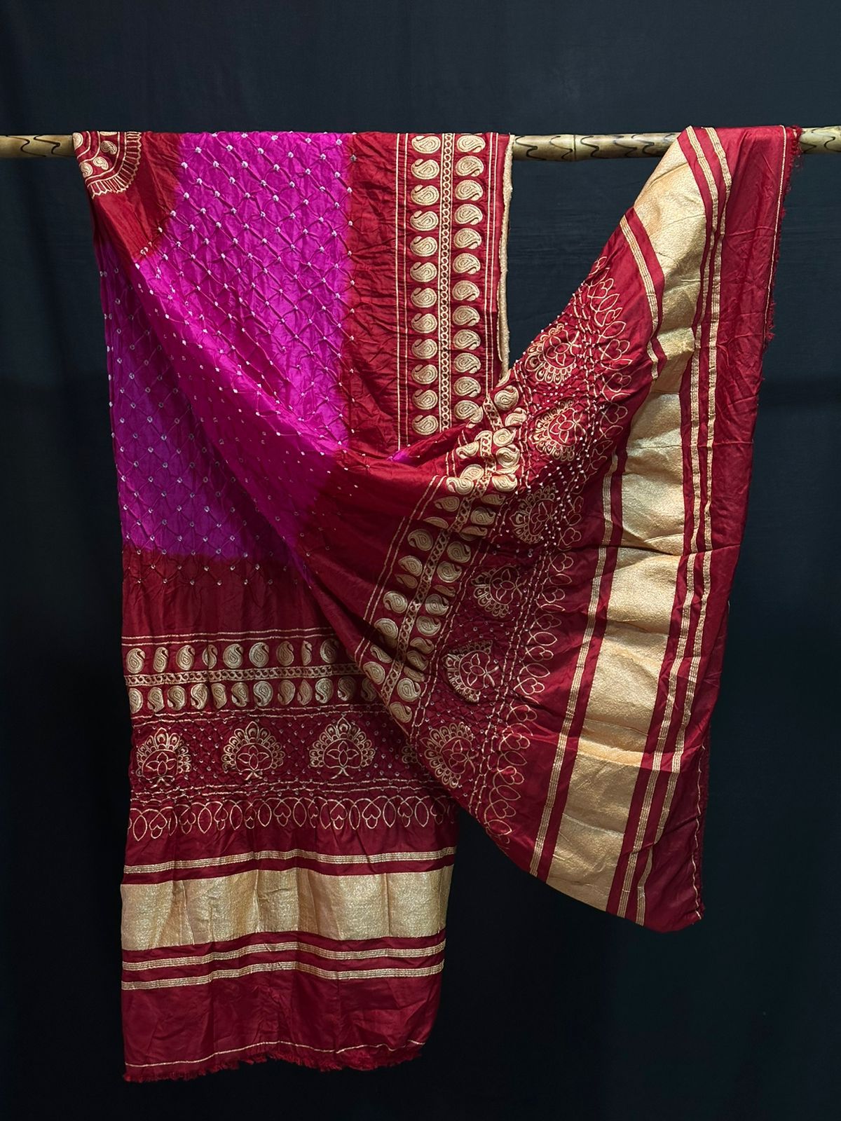 A classic black Gajji silk Bandhani dupatta with a grey-blue tie-dye section and a contrasting heavy gold Zari border.