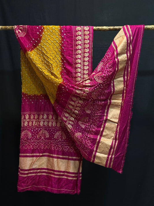A vibrant Gajji silk Bandhani dupatta in mustard yellow and rani pink, showcasing the detailed Bandhej pattern and opulent Zari pallu.