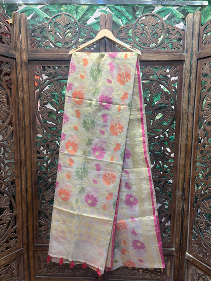 Floral patterned fabric hanging on a wooden hanger against a decorative wooden background