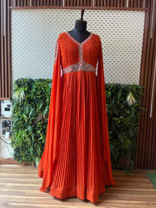 Regal Rust Pleated Gown with Embellished Cape Sleeves by Lable Rosaya