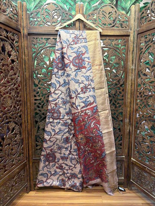 Hand-painted pure Tussar Kalamkari saree with red and blue floral motifs.