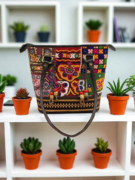 An opulent ethnic box clutch covered in hand-embroidered beads and sequins for weddings.