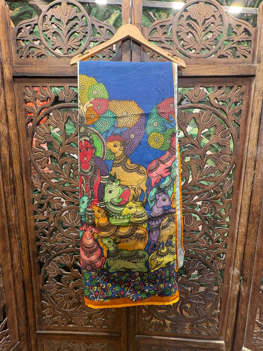 Colorful fabric with artistic design on a wooden hanger against a wooden carved background