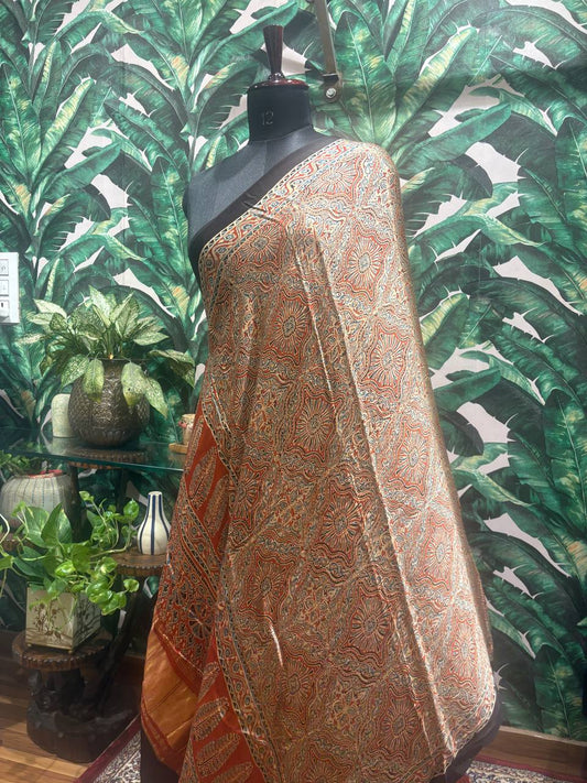 Saree draped over a mannequin against a leafy green background
