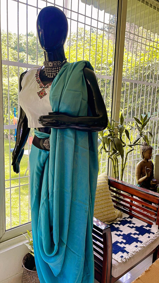 Madhubani handmade embroidery blouse paired with plain Jorzet Saree