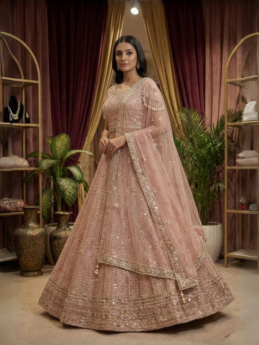 Full blush pink lehenga with heavy sequin embroidery displayed in boutique.