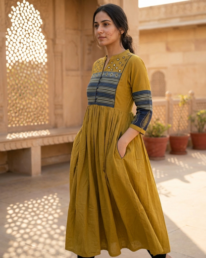 Woman wearing mustard cotton Anarkali kurta with printed yoke and pockets
